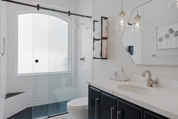 Contemporary bathroom design featuring a stylish walk-in shower and elegant dark cabinetry.