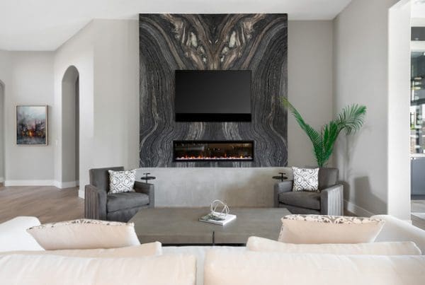 Sleek living room with white sofa, stone wall, and modern electric fireplace for cozy elegance.