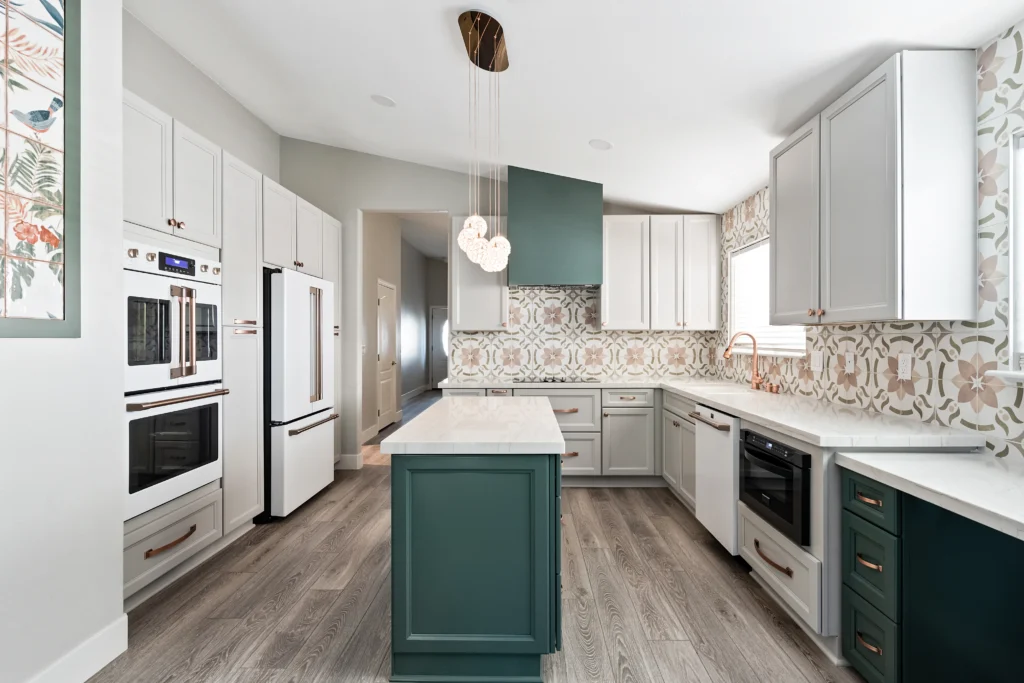 Chic modern kitchen with two-tone cabinets, geometric backsplash, and sleek stainless steel appliances.