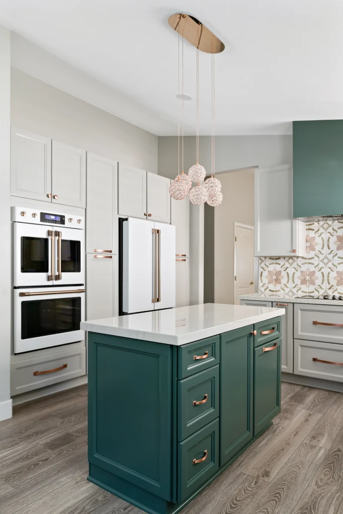 Chic modern kitchen with deep green island, muted gray cabinetry, and stylish brass accents.