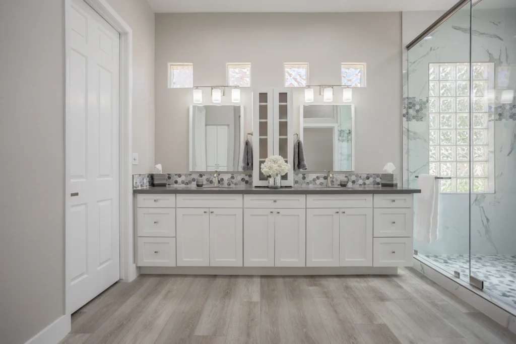 Modern dual vanity bathroom with elegant design, natural light, and luxurious shower features.