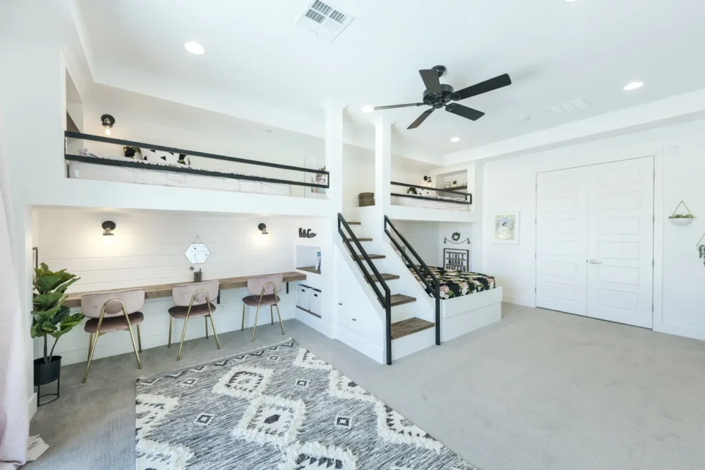 Modern multi-level loft beds in a stylish, airy room with a functional workspace.