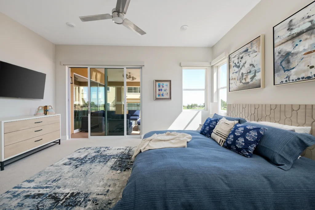 Contemporary blue bedroom design with natural light, inviting decor, and serene atmosphere by Reveal Interior Design.