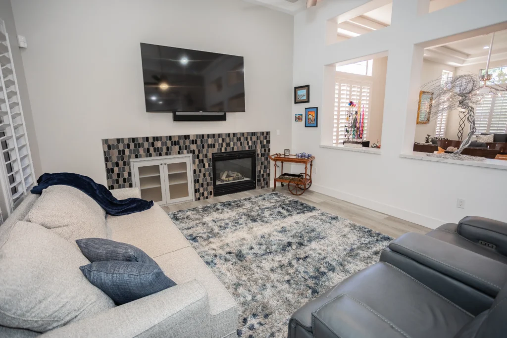 Stylish modern living room with plush seating, sleek fireplace, and natural light.