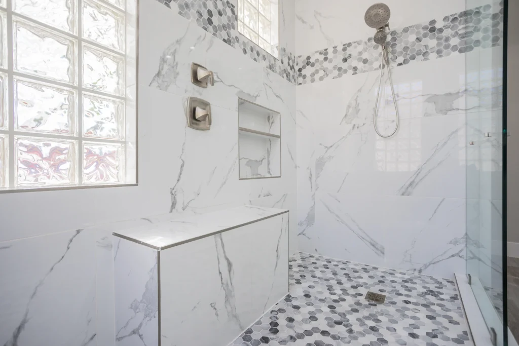 Luxurious marble shower oasis with natural light, sleek fixtures, and minimalist design elements.