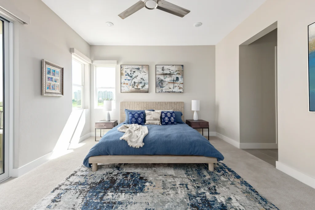 Serene bedroom design featuring blue accents, natural light, and elegant decor by Las Vegas designer.