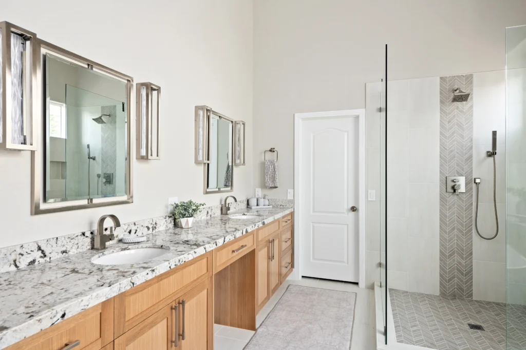 Sleek granite vanity and modern shower create a serene, inviting bathroom retreat.