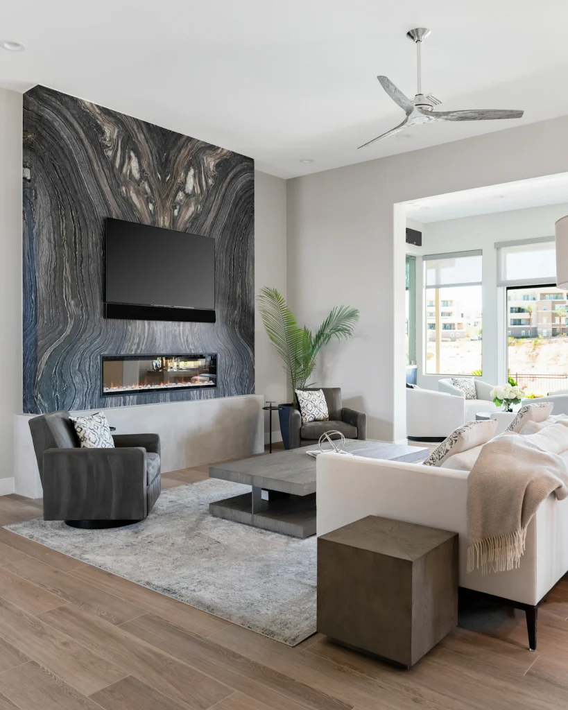 Stylish living room with textured stone wall, modern furniture, and abundant natural light.