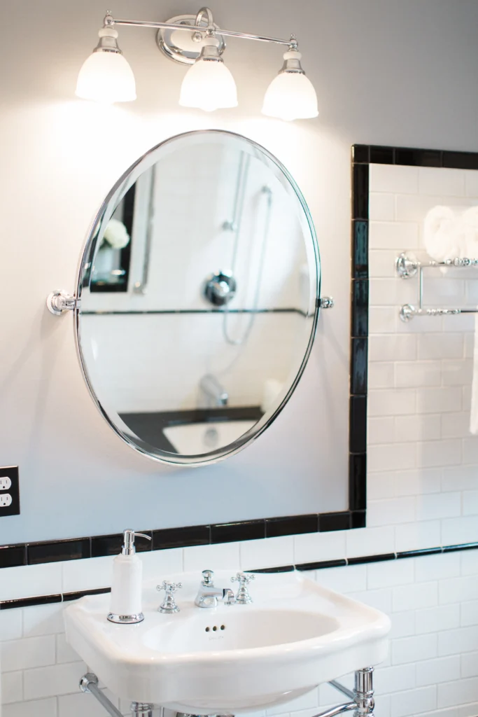 Sleek modern bathroom with an elegant mirror, stylish sink, and chic tile accents.