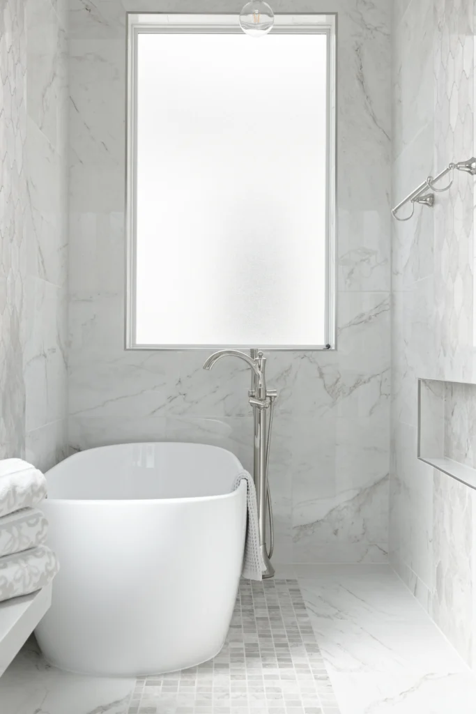 Luxurious modern bathroom with marble finishes and a freestanding bathtub for ultimate relaxation.