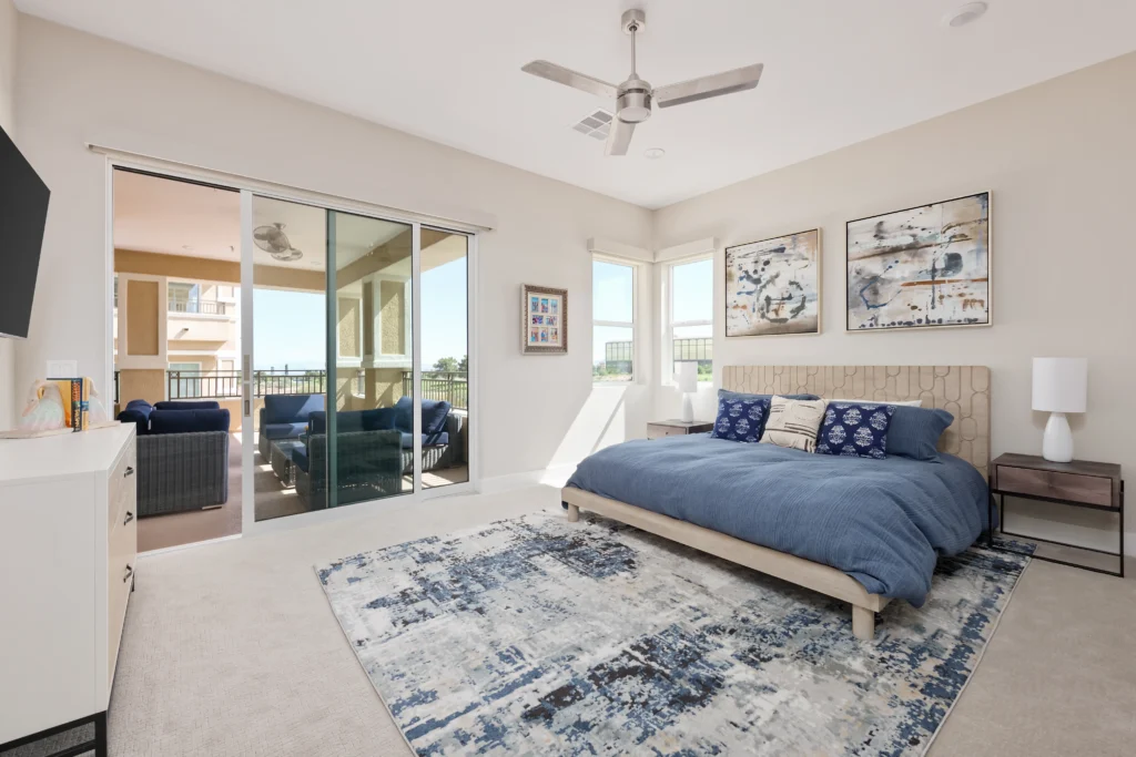 Stylish modern bedroom with serene decor, natural light, and a cozy balcony retreat.