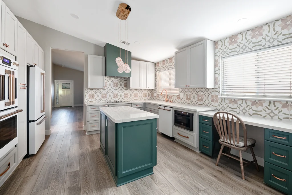 Stylish modern kitchen in Las Vegas with white cabinetry and green accents, featuring a functional island.