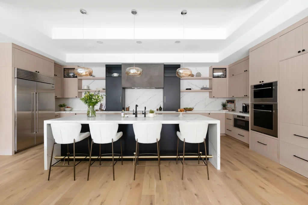 Modern kitchen with stylish beige and navy cabinetry, elegant island, and bright, airy atmosphere.