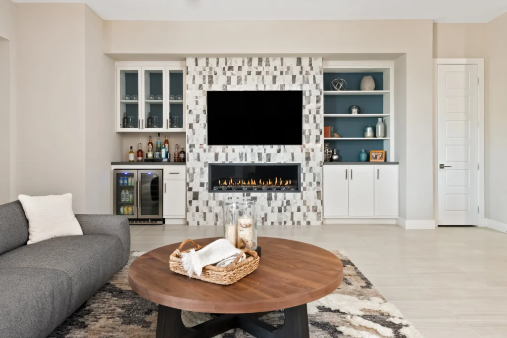 Modern living room featuring a sleek fireplace, built-in cabinetry, and a cozy sectional sofa.