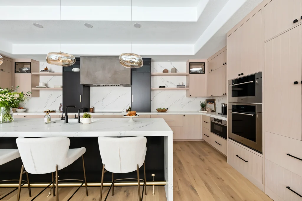 Chic modern kitchen with two-tone cabinetry, spacious island, and elegant design elements.