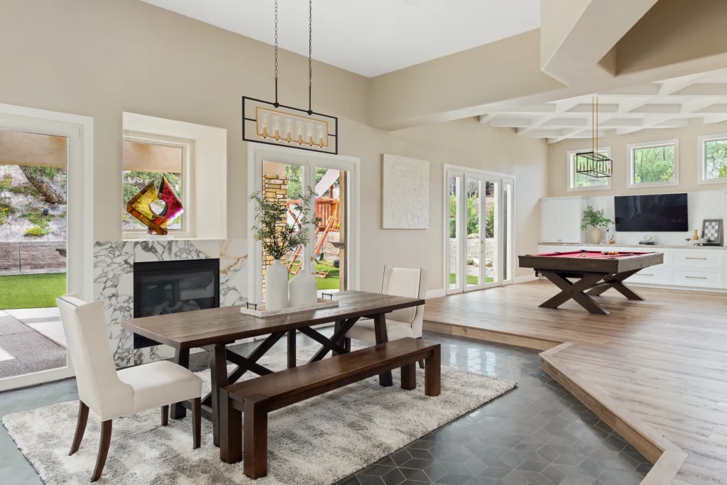 Contemporary dining area design with dark wood table, airy light, and inviting aesthetic.