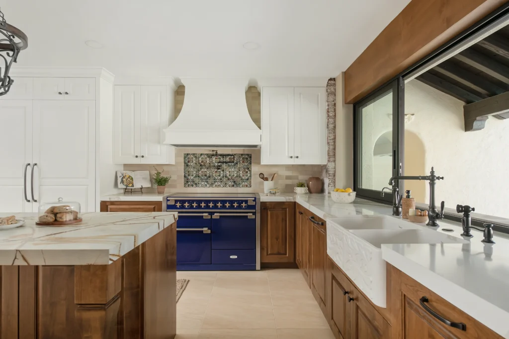 Inviting Hacienda kitchen blends modern elegance with traditional charm and a vibrant blue range cooker.