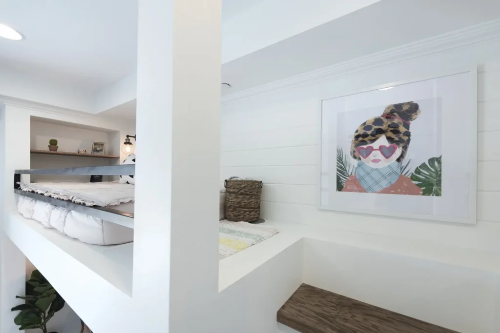 The Harvard Minimalist Loft Bedroom Design Modern minimalist loft bedroom with vibrant artwork, wooden accents, and functional storage solutions.