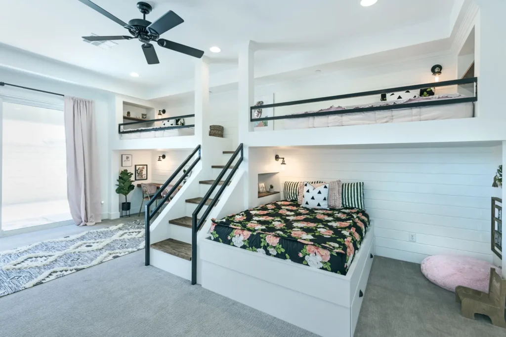 Playful Bunk Bed Design in The Harvard Project Modern bedroom with playful bunk beds, vibrant bedding, and cozy reading nook in natural light.
