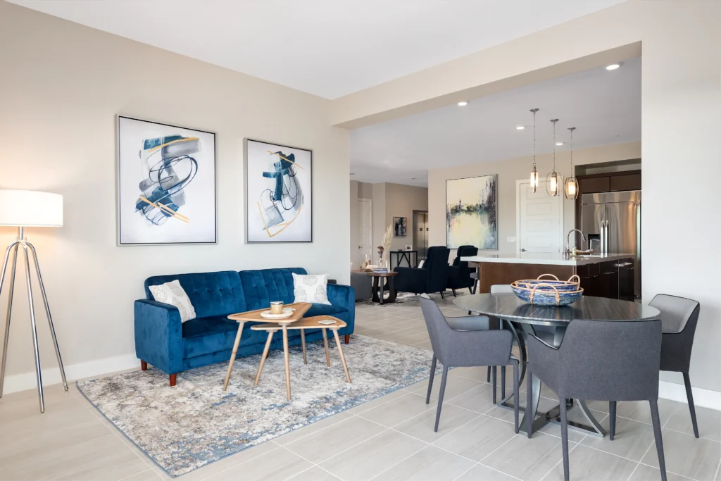 Modern living space in Las Vegas with plush blue sofa, chic dining area, and stylish decor.