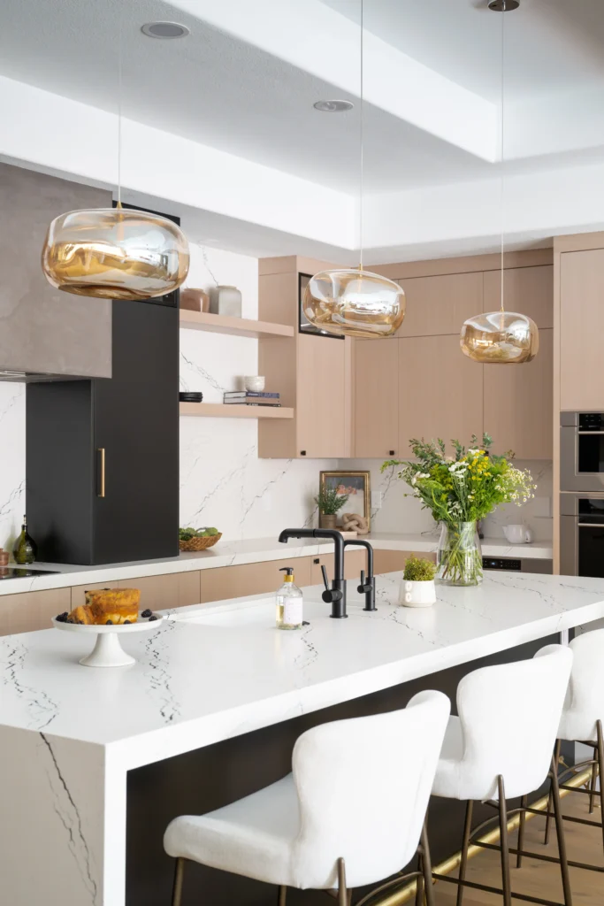 Modern kitchen with elegant island, stylish seating, and warm pendant lighting for inviting ambiance.