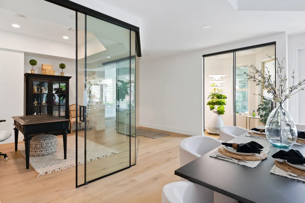 Modern workspace in Las Vegas with elegant design, glass partitions, and inviting dining area.