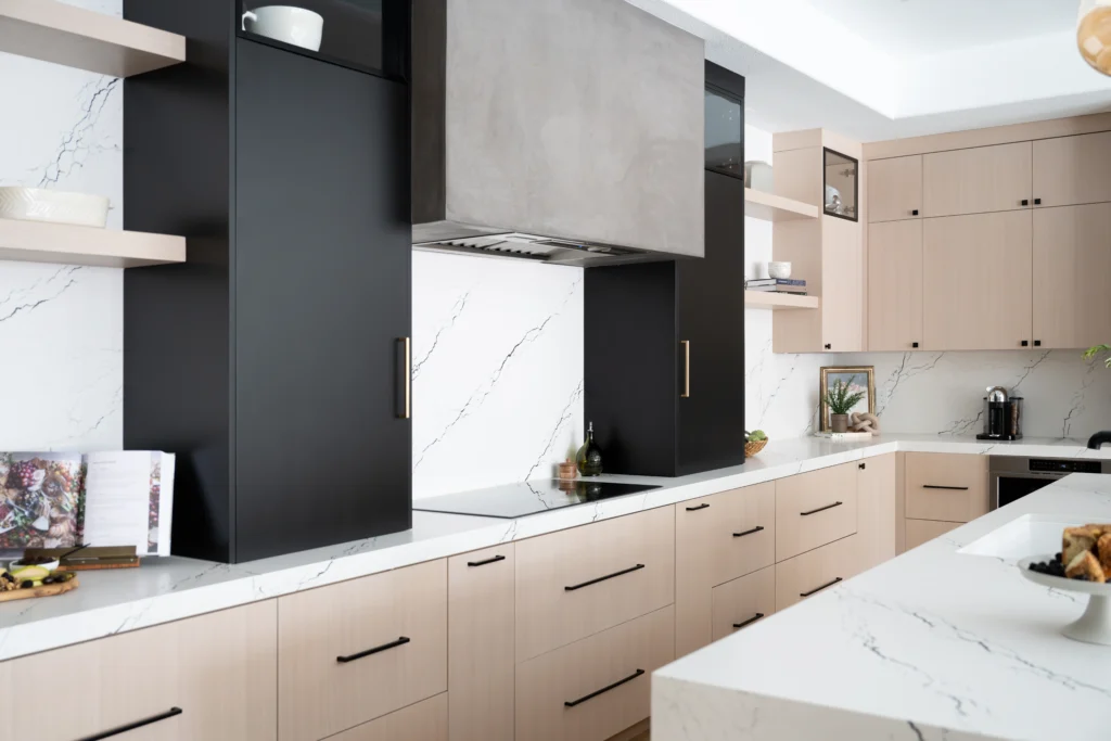 Elegant modern kitchen design with light wood, black accents, and luxurious marble features.