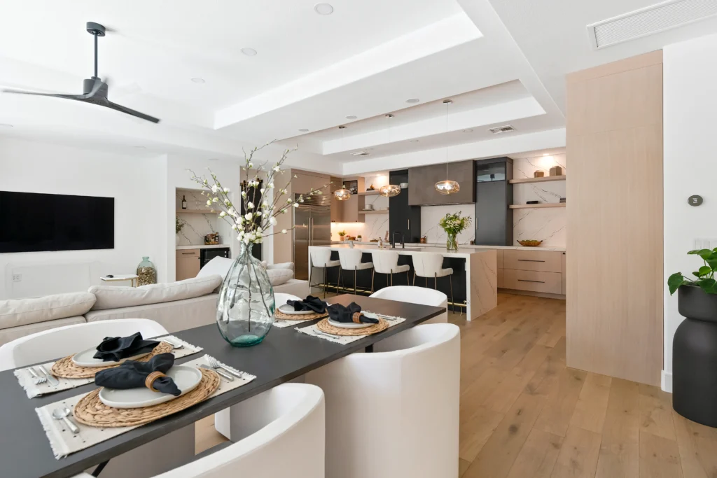 Elegant open-concept living and dining area with modern design, stylish furnishings, and vibrant greenery.