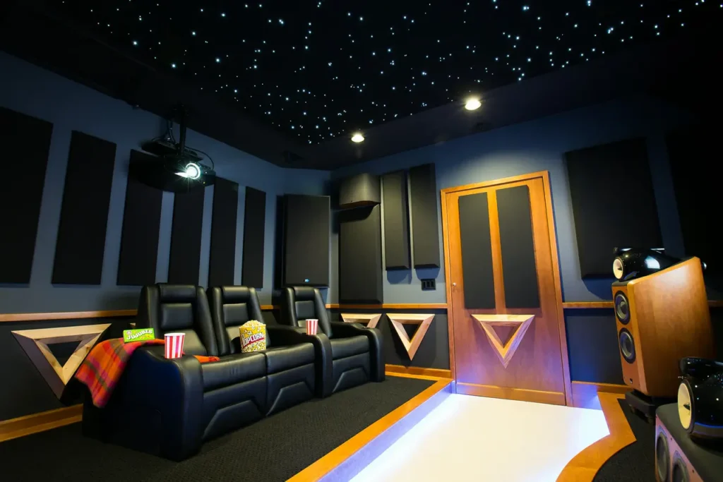 Modern home theater with plush seating, soundproof walls, and starry ceiling lights.