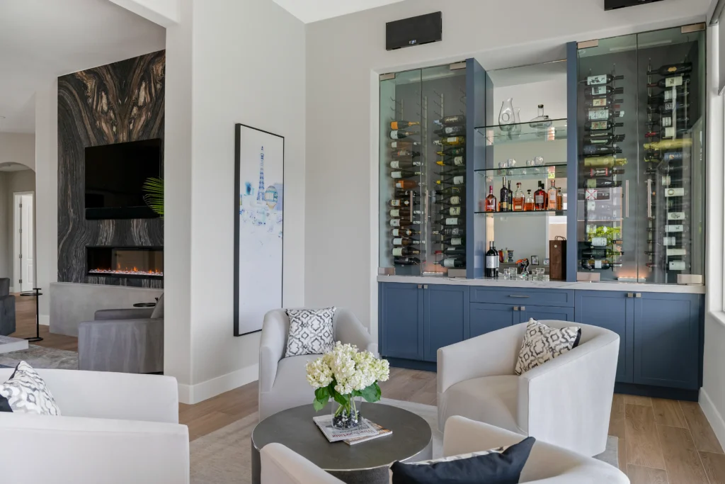 Modern lounge with elegant wine bar, plush seating, and natural light for inviting gatherings.