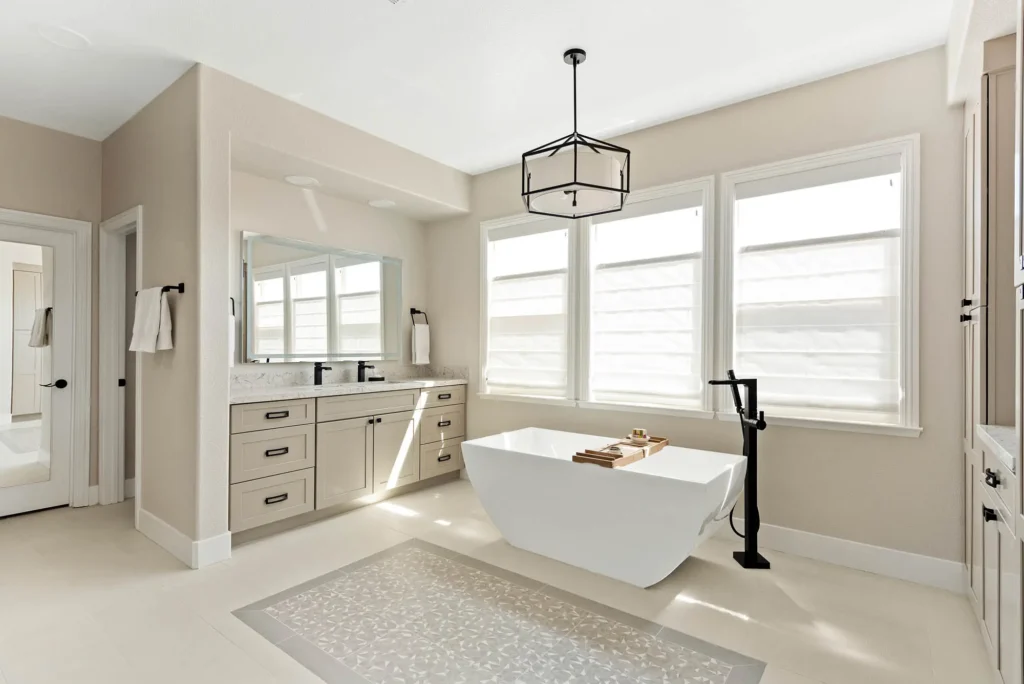 Contemporary luxury bathroom with freestanding tub, natural light, and elegant wood finishes.