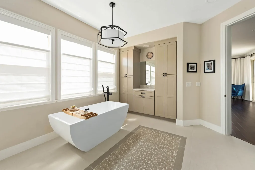 Elegant Raven bathroom with a natural light-filled tub, soft hues, and modern decor.