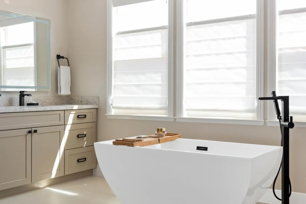 Elegant modern bathroom retreat in Las Vegas with a freestanding tub and abundant natural light.