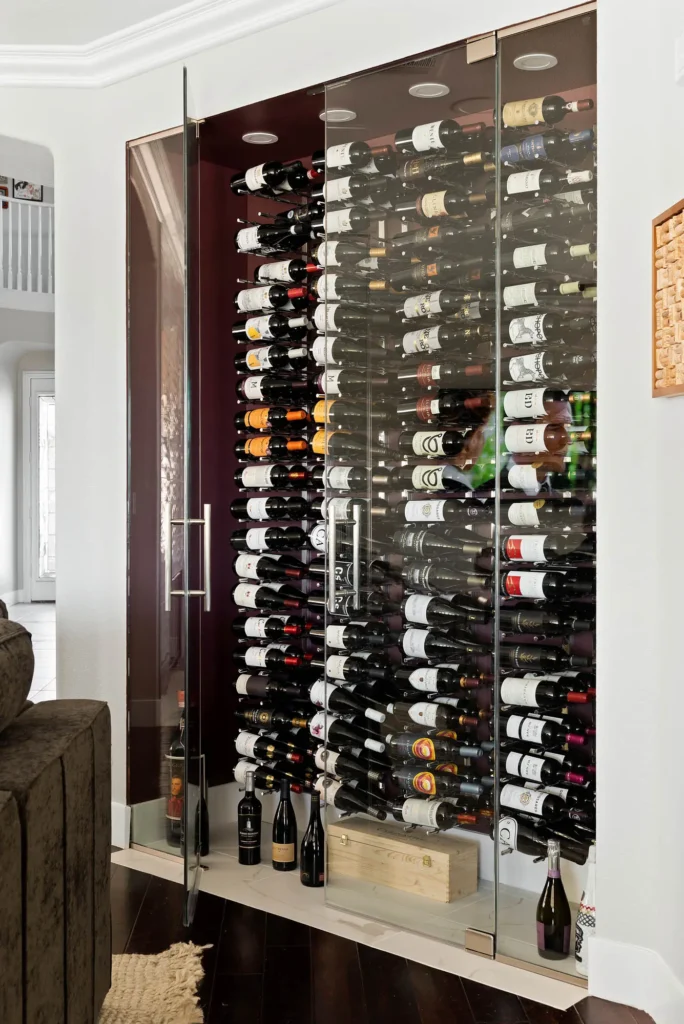 Stylish modern wine cellar with glass doors, organized bottles, and elegant ambient lighting.