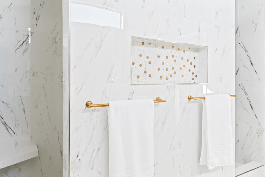 Sophisticated Underwood bathroom with marble niche, gold accents, and serene minimalist design.