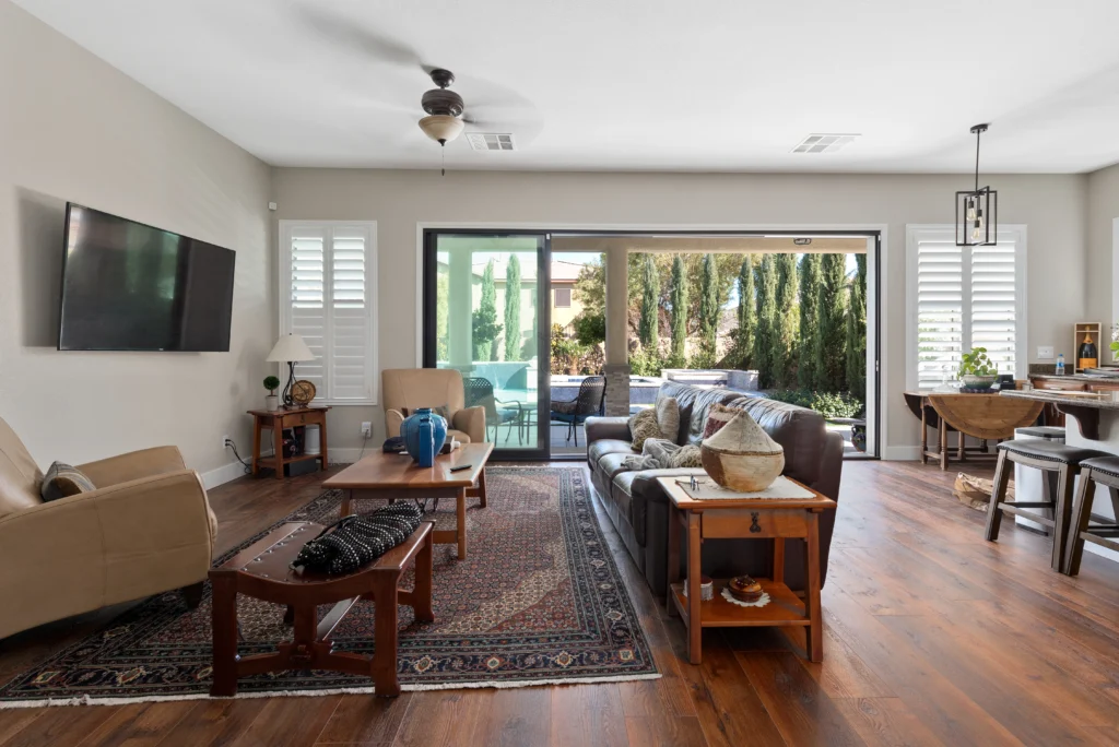 Modern living space with beige walls, cozy seating, and seamless indoor-outdoor flow.