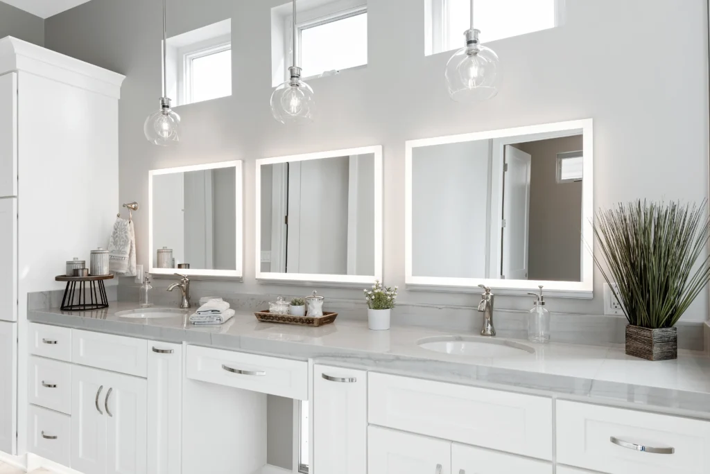 Elegant modern bathroom with gray countertop, white cabinetry, and inviting natural lighting.