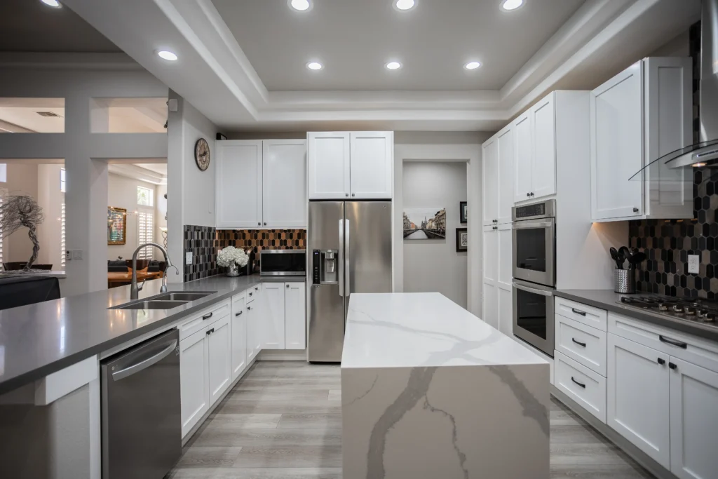 Elegant modern kitchen with white cabinetry, a stylish island, and integrated appliances for entertaining.