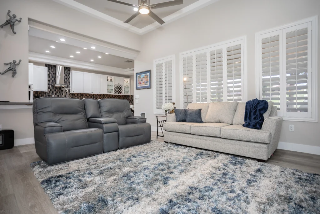 Contemporary living room design with cozy accents, bright light, and stylish furnishings in neutral tones.