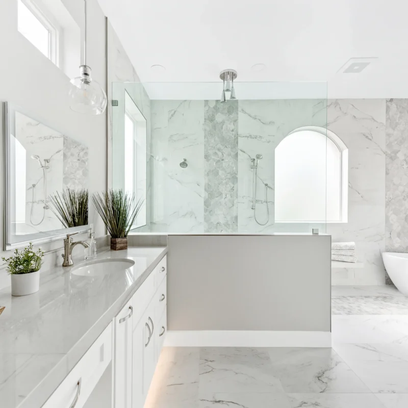 Elegant marble bathroom with a soaking tub, double vanity, and abundant natural light.