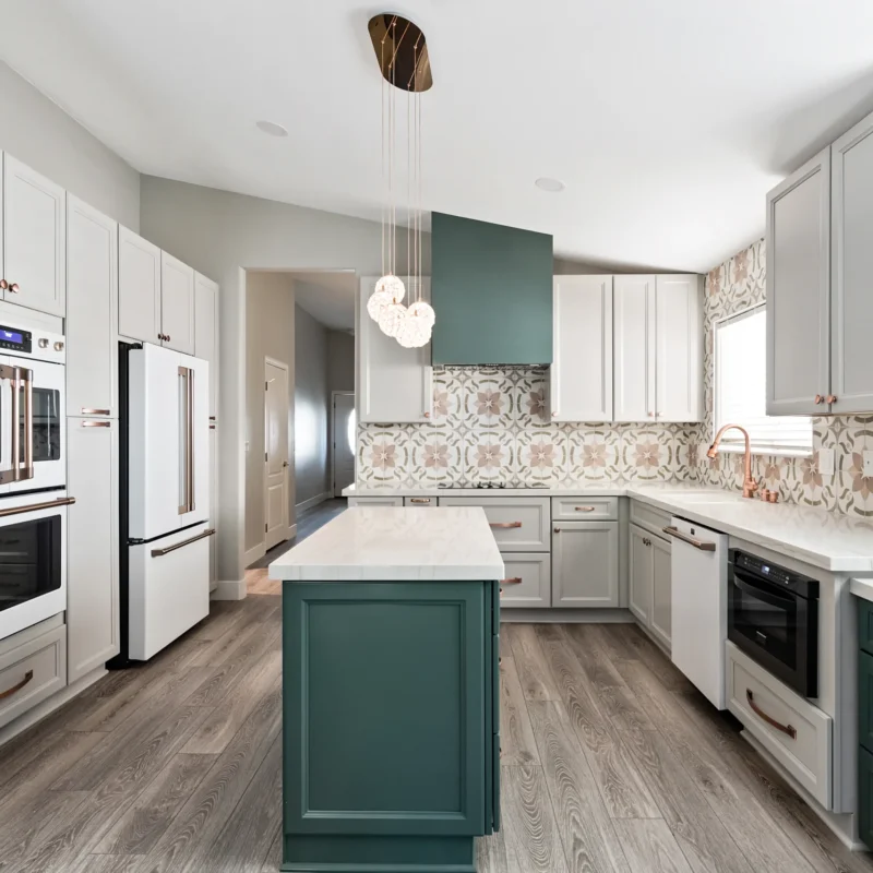 Modern Las Vegas kitchen with green accents and white cabinetry, perfect for cooking and gatherings.