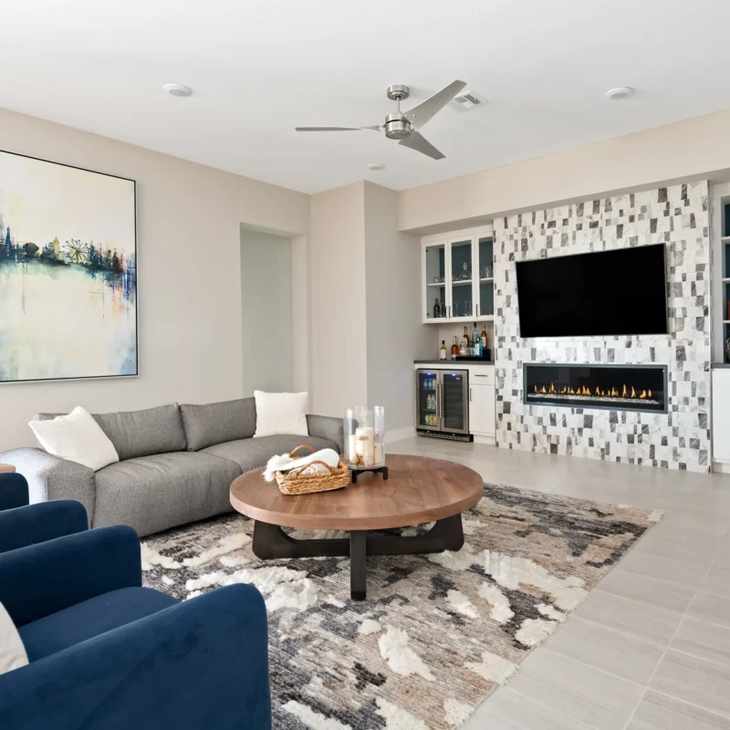 Inviting contemporary living room design with cozy furnishings and a stylish electric fireplace.