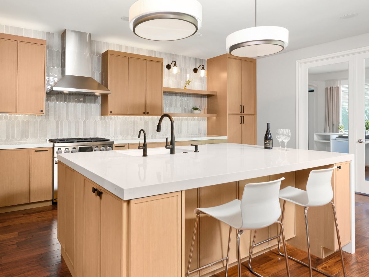 Contemporary kitchen with warm stained oak slim shaker cabinetry and quartz island, Reveal Interior Design Las Vegas