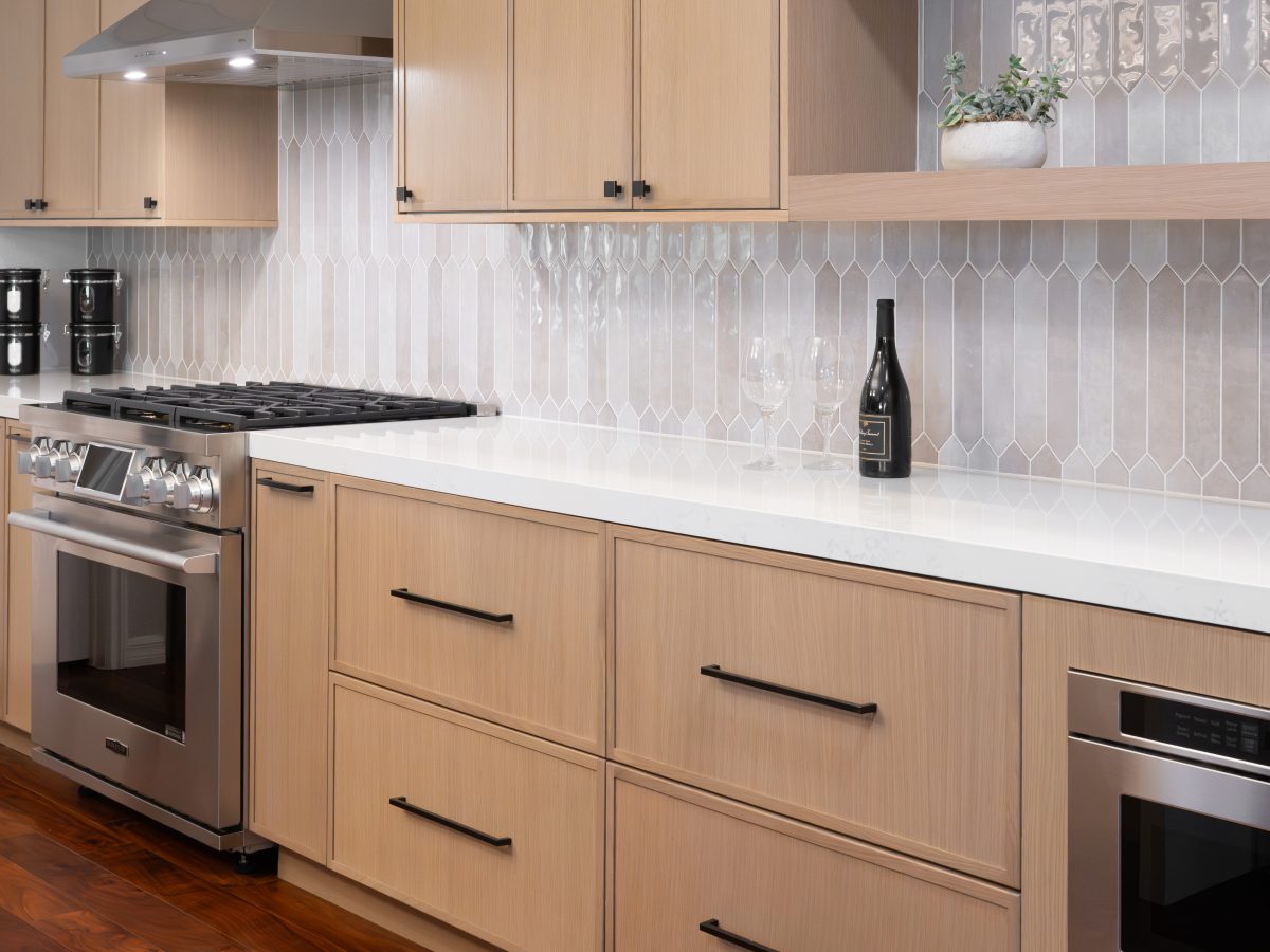 Warm oak shaker kitchen with handmade-look picket backsplash tile and quartz countertops, Reveal Interior Design Las Vegas
