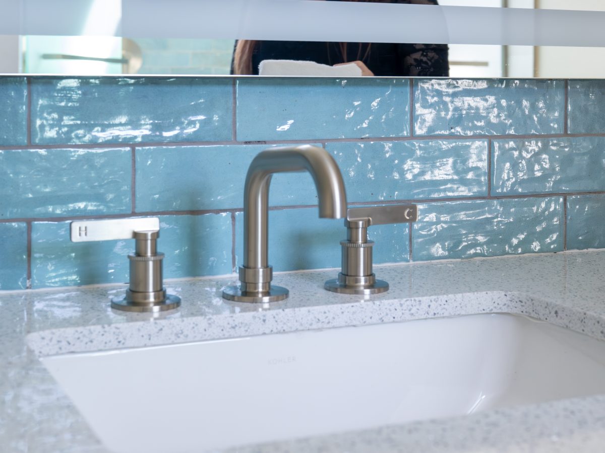 Primary bathroom vanity with white quartz countertop, brushed nickel fixtures, and handmade teal subway tile, Reveal Interior Design Las Vegas