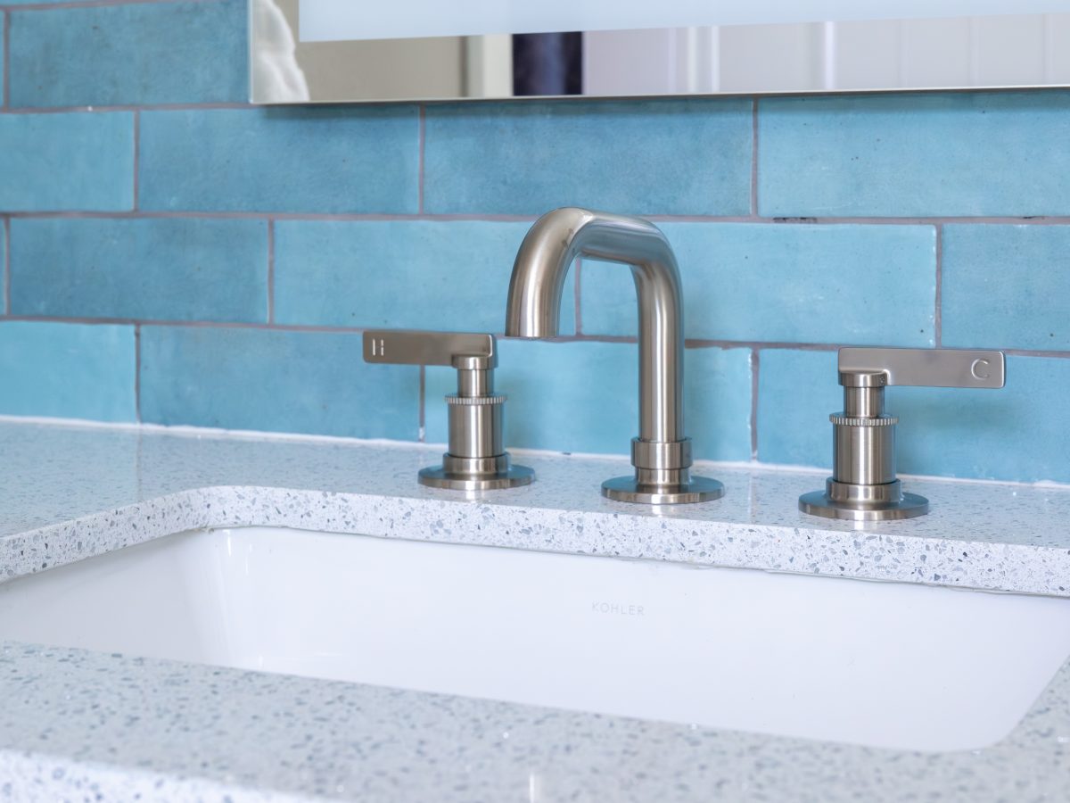 Primary bathroom vanity with white glitzy quartz countertop, brushed nickel fixtures, and handmade teal subway tile, Reveal Interior Design Las Vegas
