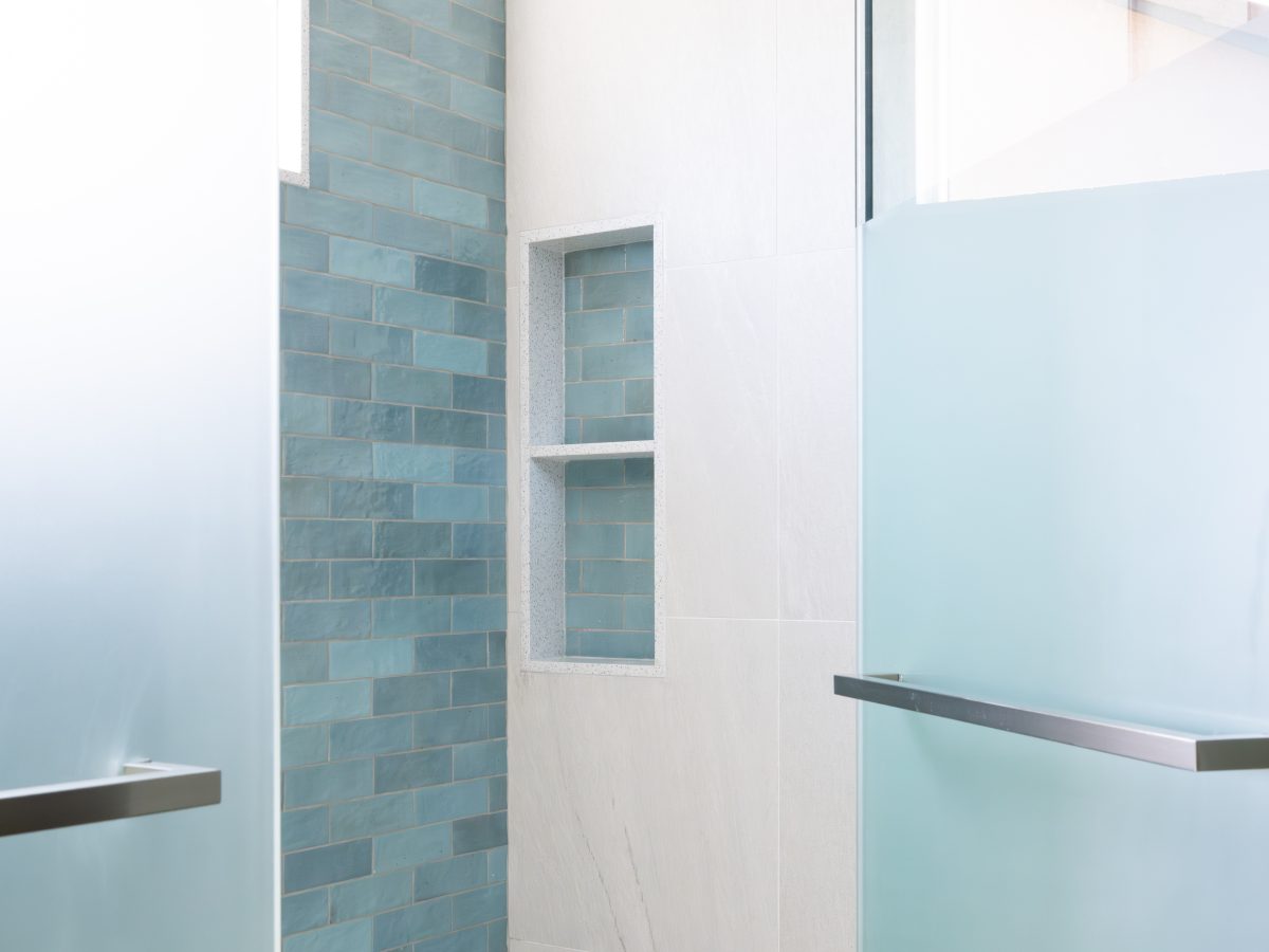 Spa primary shower with handmade teal subway tile, ceiling rain head, and custom privacy glass, Reveal Interior Design Las Vegas