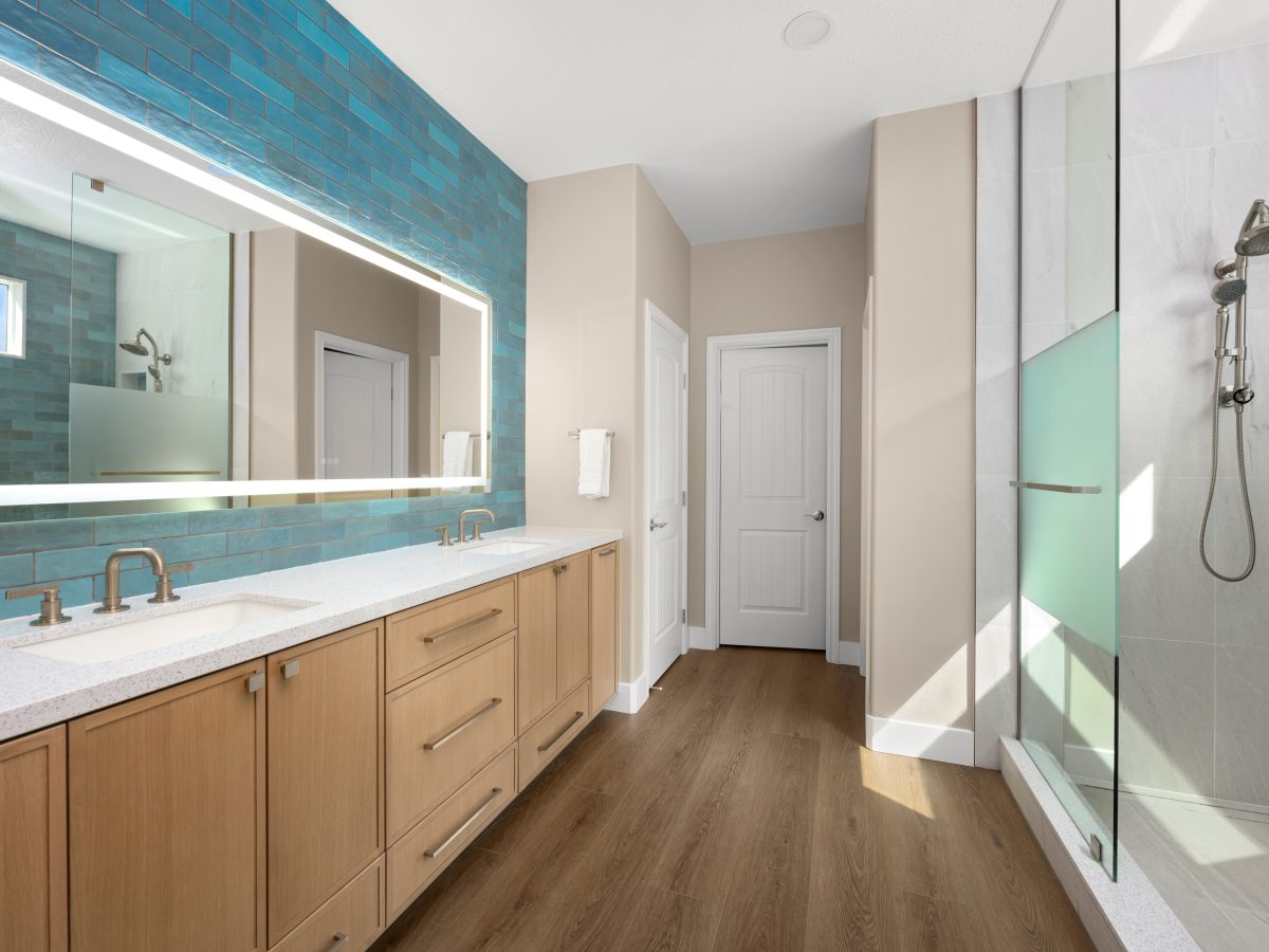 Spa primary bathroom with handmade teal subway tile, warm oak vanity, and walk-in shower, Reveal Interior Design Las Vegas