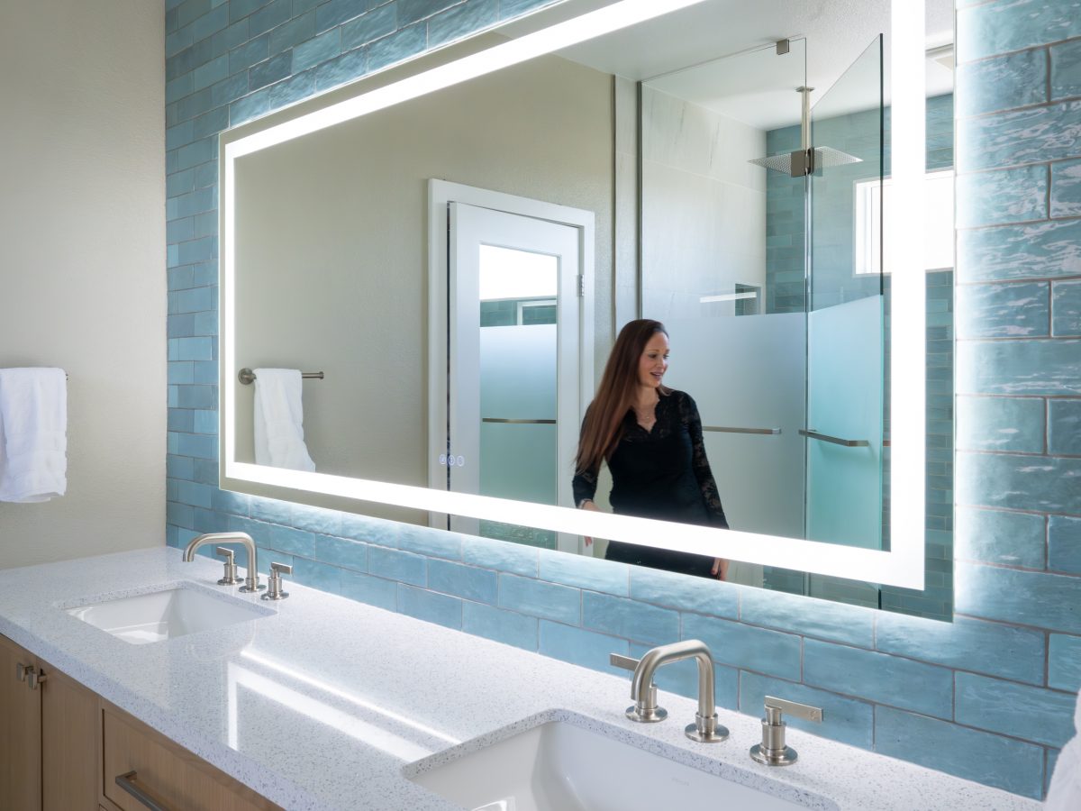 Spa primary bathroom with LED mirror, handmade teal subway tile, and white quartz double vanity, Reveal Interior Design Las Vegas