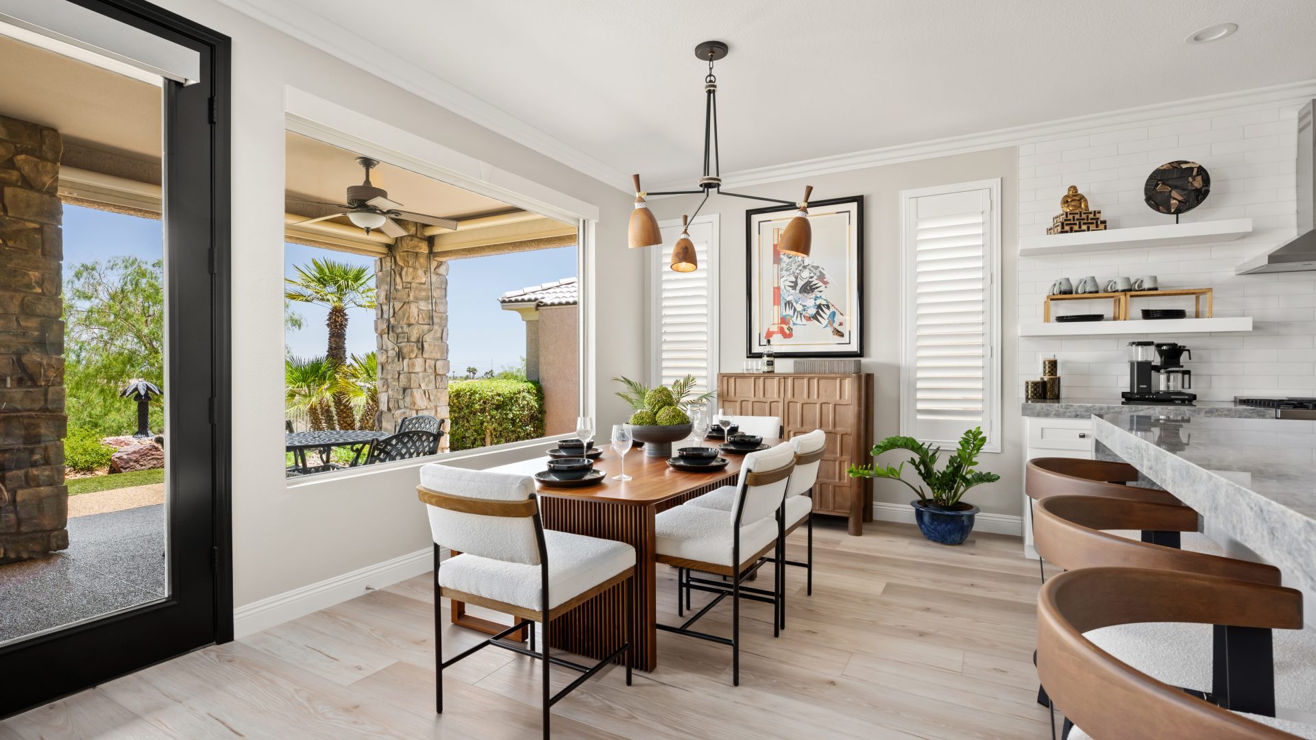 Japandi-inspired dining room with walnut table, cloud-fabric seating, and sculptural wood-and-metal chandelier, Reveal Interior Design Las Vegas